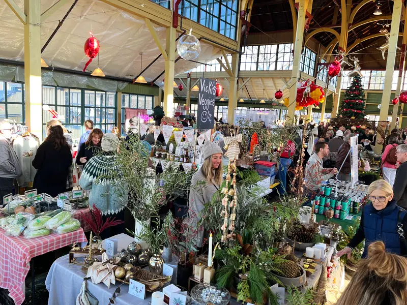 Shoppers browsing Vicki's Veggies and local artisan stalls near the giant Christmas tree in Picton.