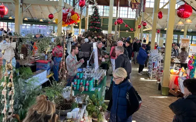 The historic Crystal Palace in Picton filled with shoppers and festive red ornaments for the Holly Jolly Market.